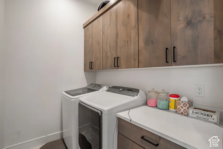 Laundry room featuring cabinet space and washing machine and dryer