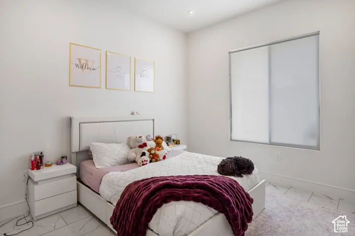 Bedroom featuring marble finish flooring and recessed lighting