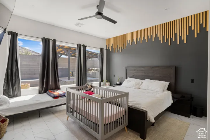 Bedroom with light marble finish flooring and a ceiling fan