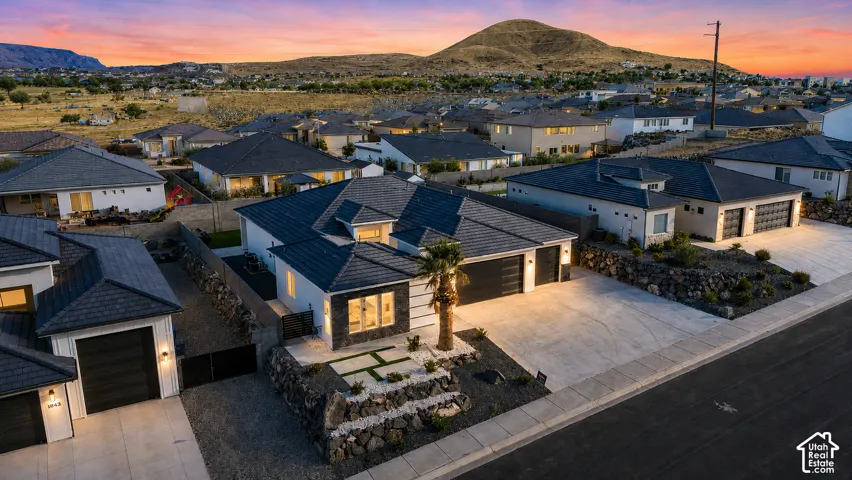 Contemporary single-story residence featuring a textured black roof, white exterior siding, and dark accent stone