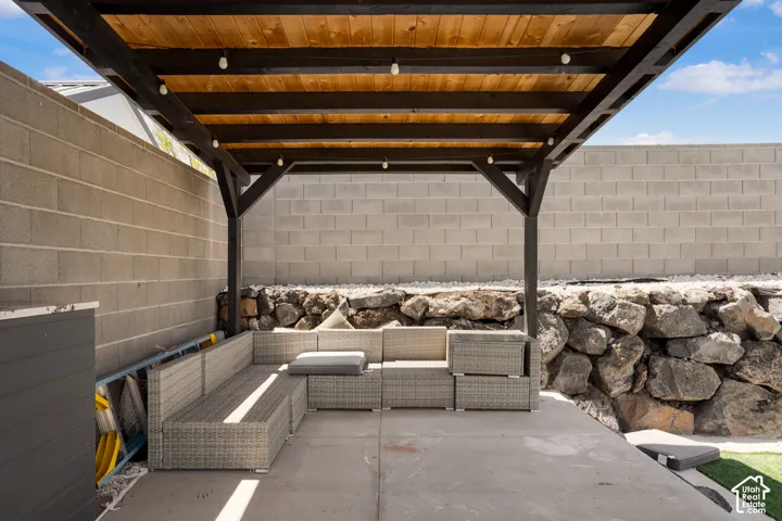 Fenced backyard with an outdoor lounge area and a patio
