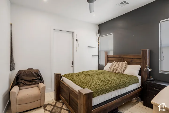 Bedroom with ceiling fan and recessed lighting