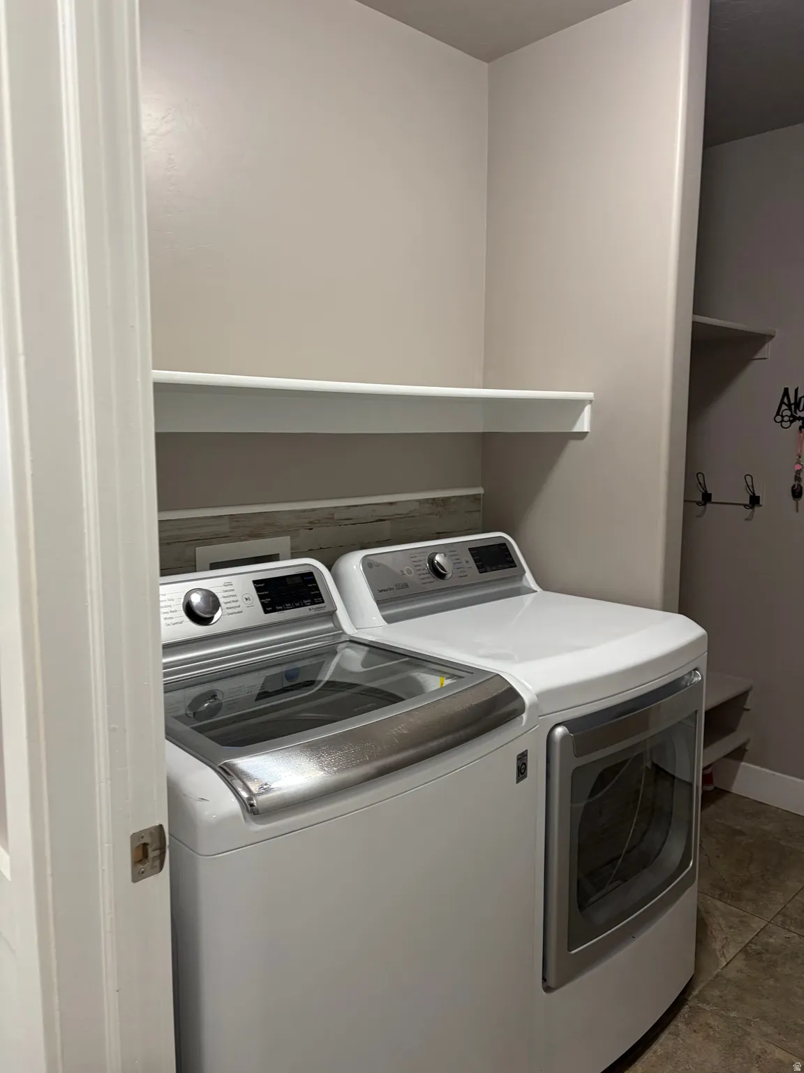 Laundry area featuring independent washer and dryer and baseboards