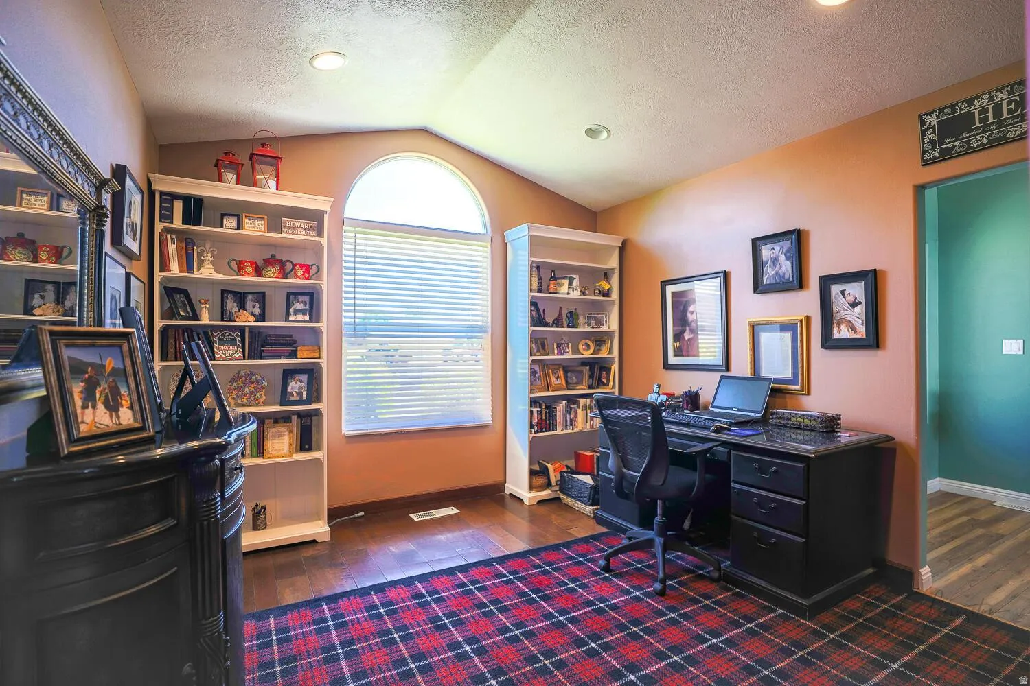 Home office featuring dark wood-style floors and a textured ceiling