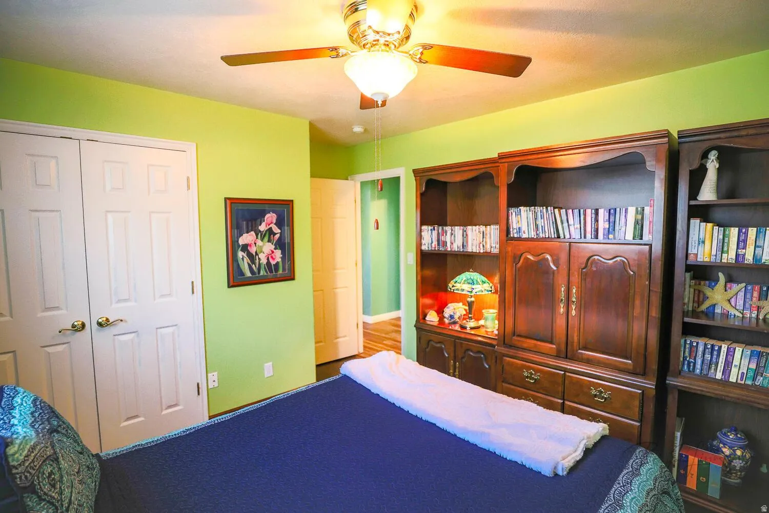 Bedroom with ceiling fan and a closet