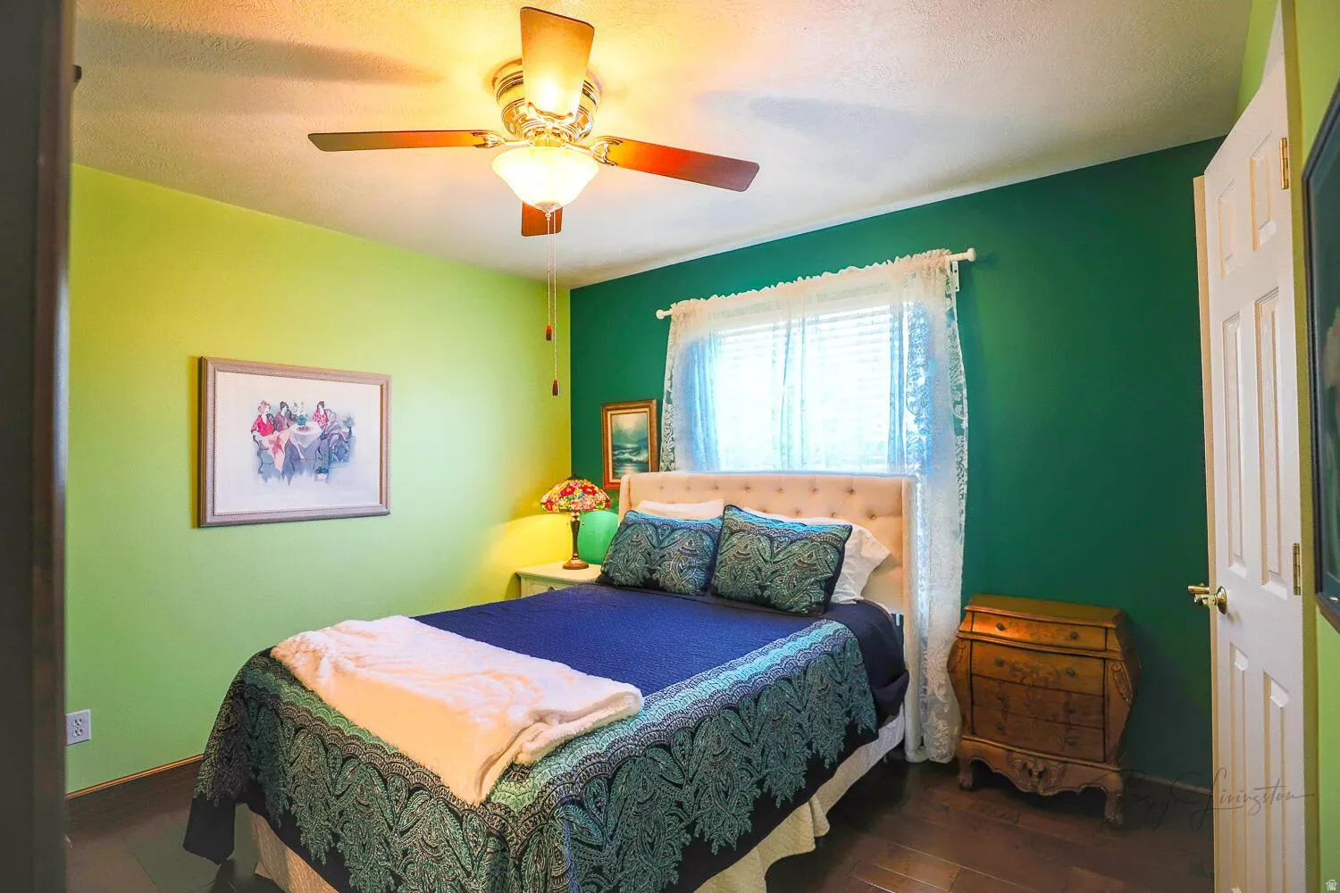 Bedroom with dark wood finished floors and ceiling fan