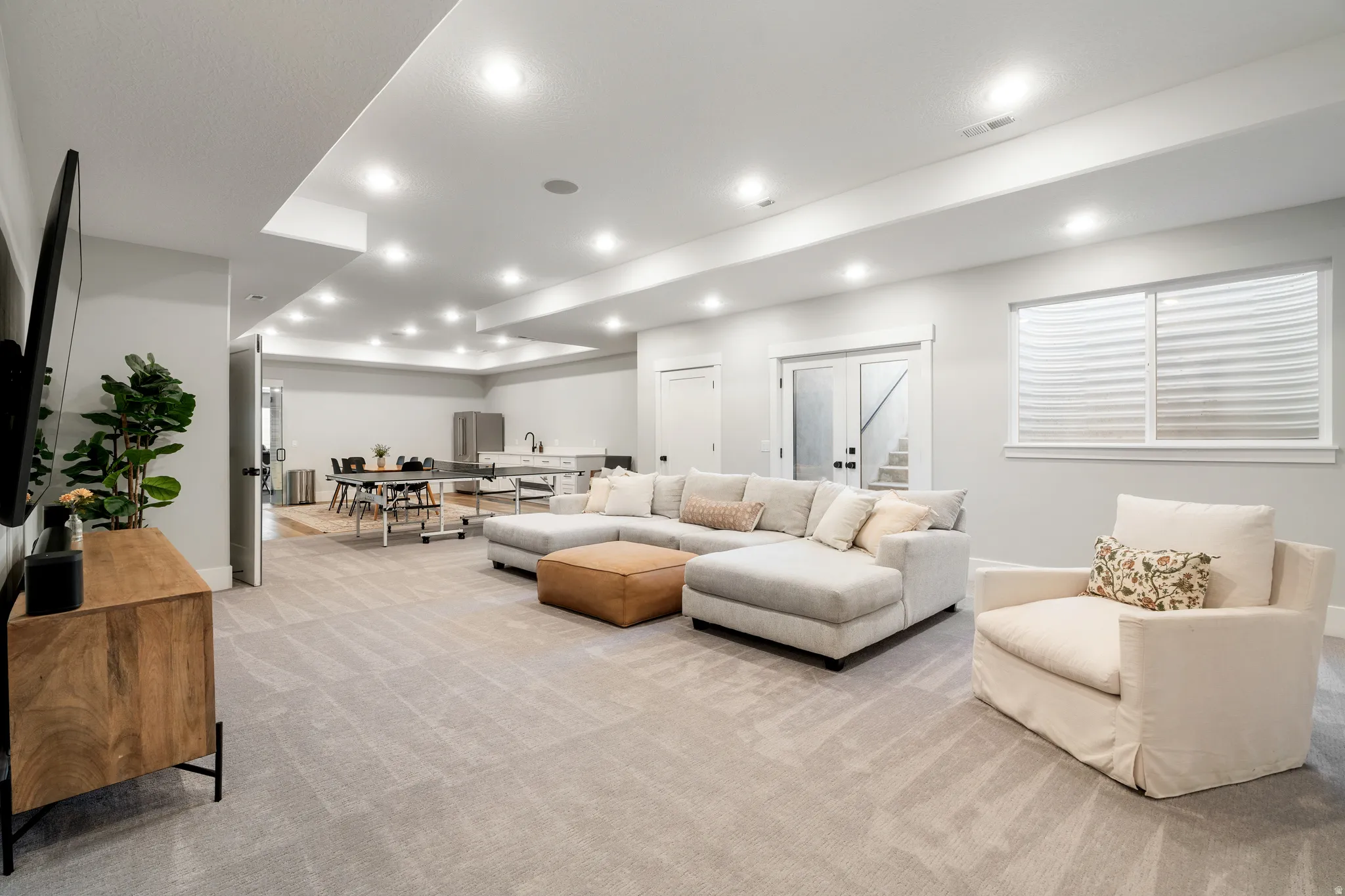 Living room featuring light colored carpet and recessed lighting