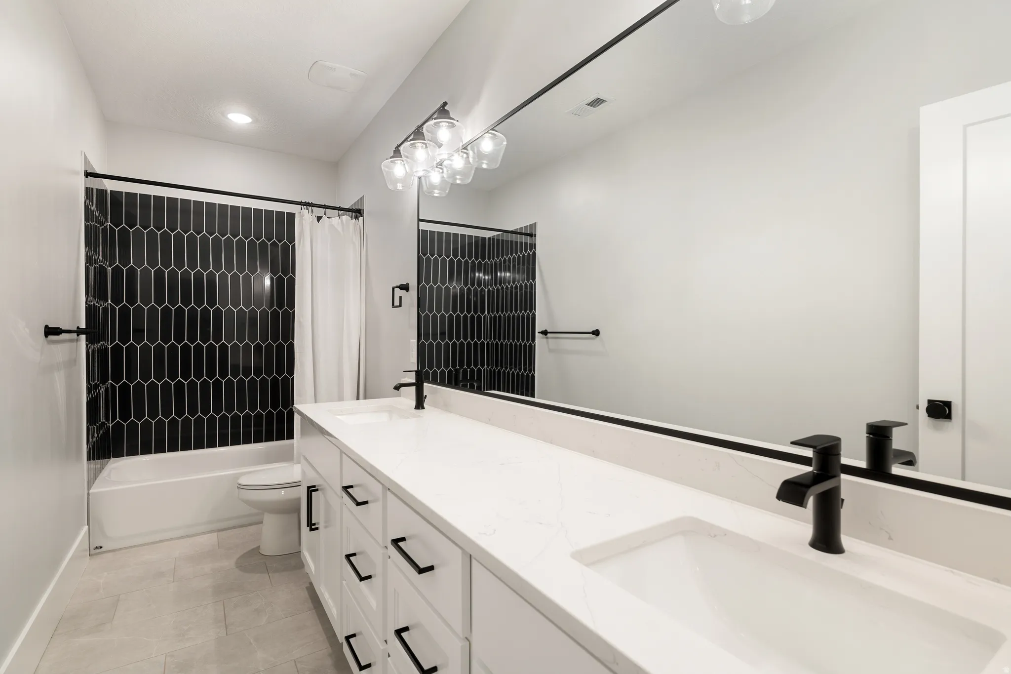 Full bath featuring double vanity and shower / tub combo with curtain