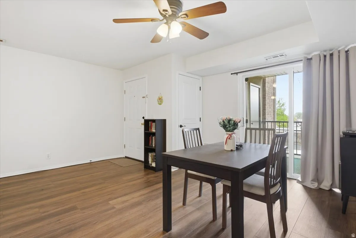 Dining area featuring wood finished floors and ceiling fan