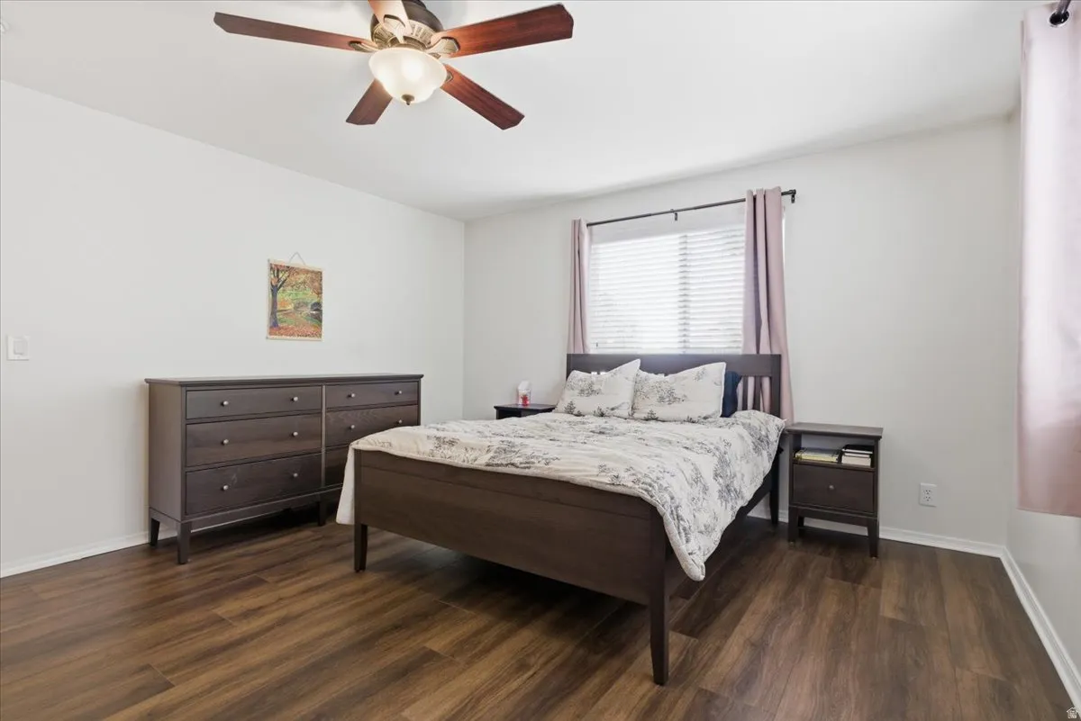 Bedroom featuring dark wood-style flooring and a ceiling fan