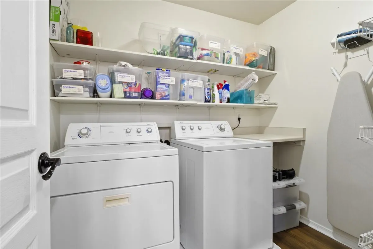 Laundry area featuring dark wood-style floors and separate washer and dryer
