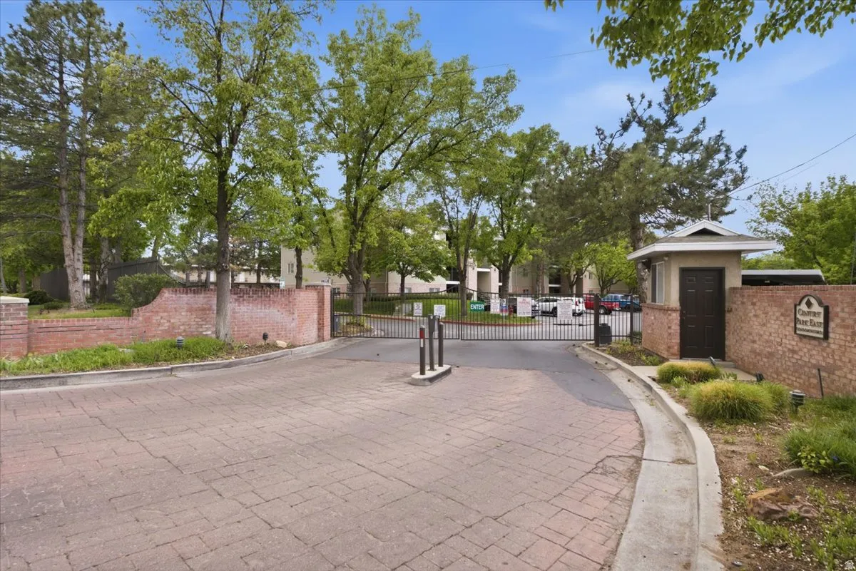 View of street featuring a gate, curbs, and a gated entry