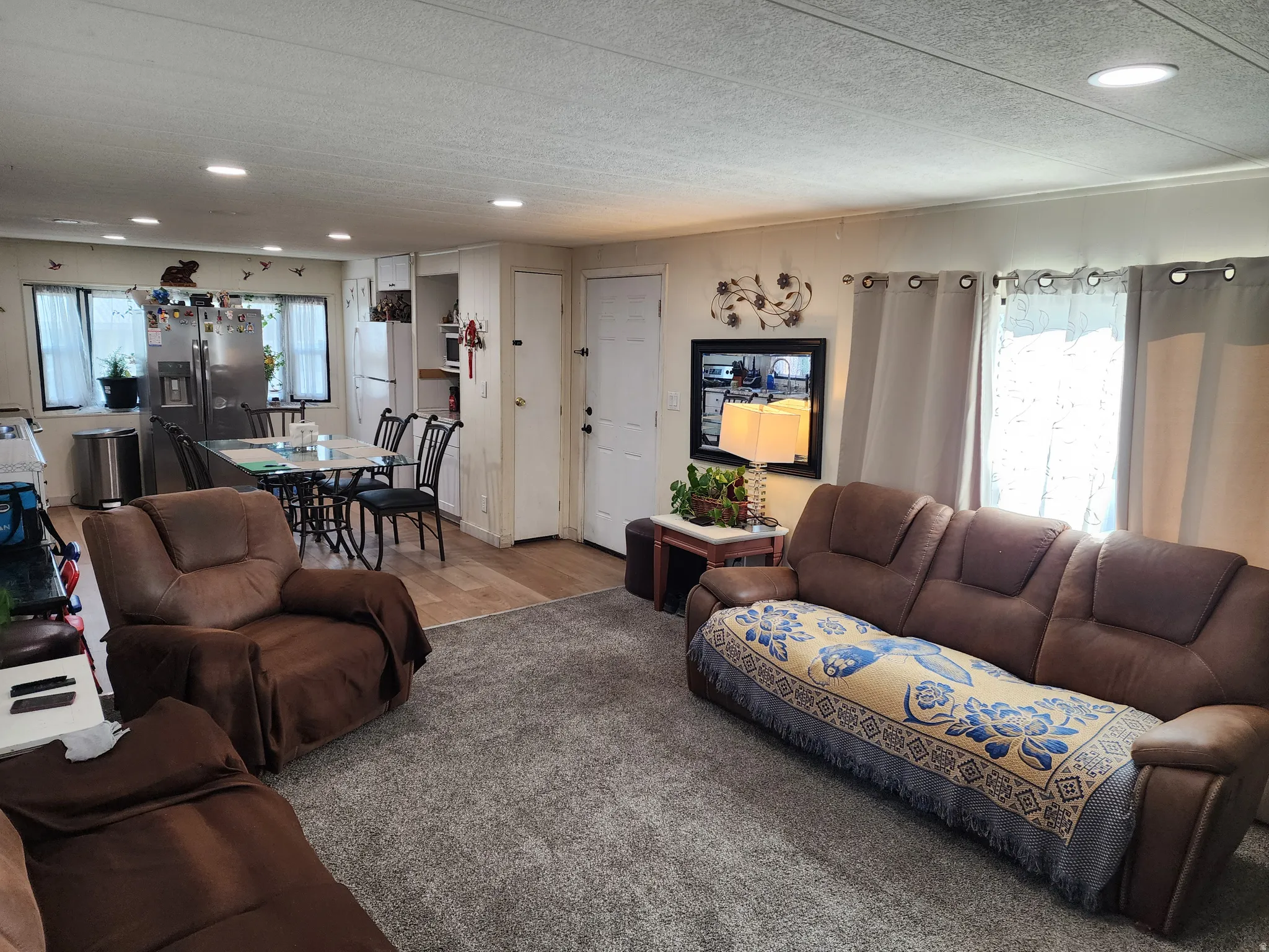 Living room featuring healthy amount of natural light, recessed lighting, a textured ceiling, and wood finished floors