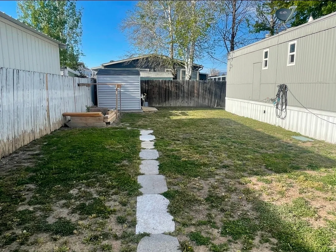 Fenced backyard with a storage shed