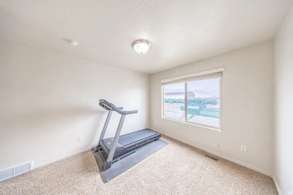 2nd bedroom featuring neutral-toned carpet flooring and light-colored walls