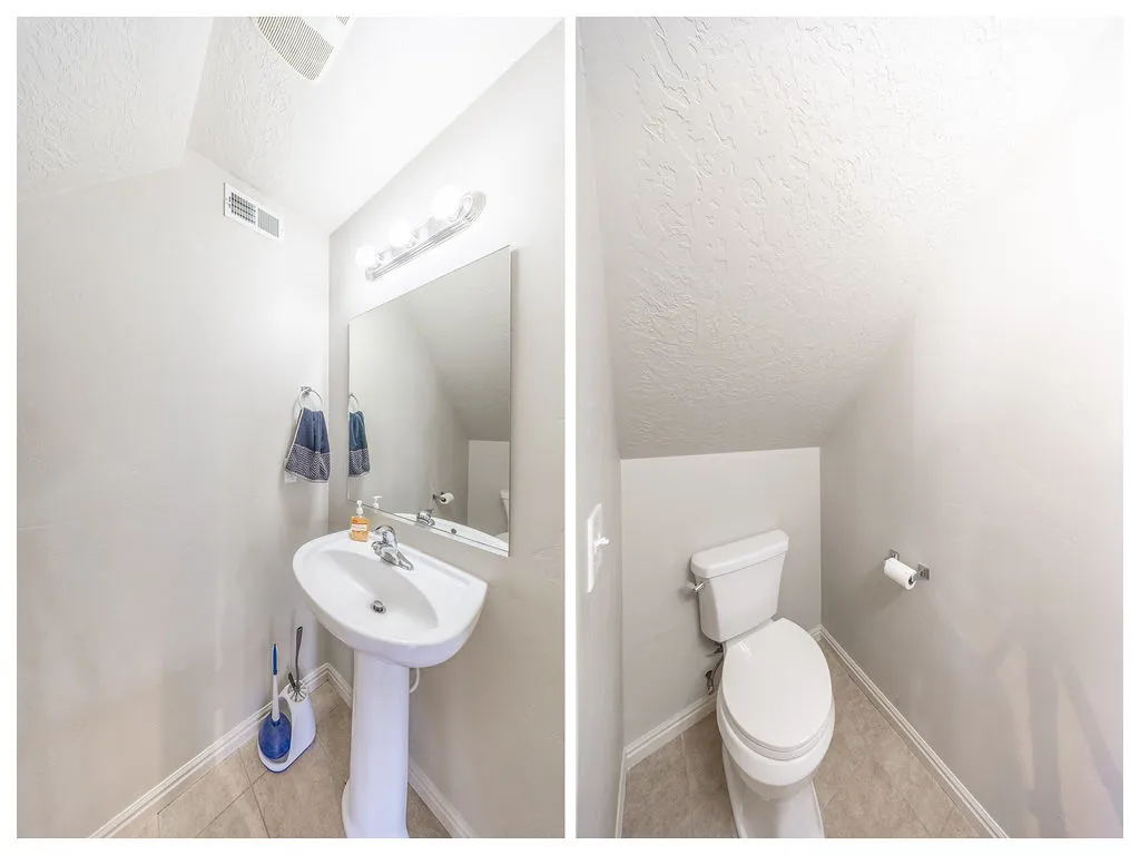 Powder room featuring a pedestal sink, wall-mounted mirror, vanity lighting fixture, and tile flooring