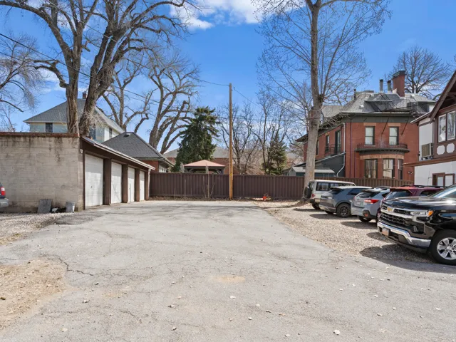 View of parking featuring a residential view and a garage