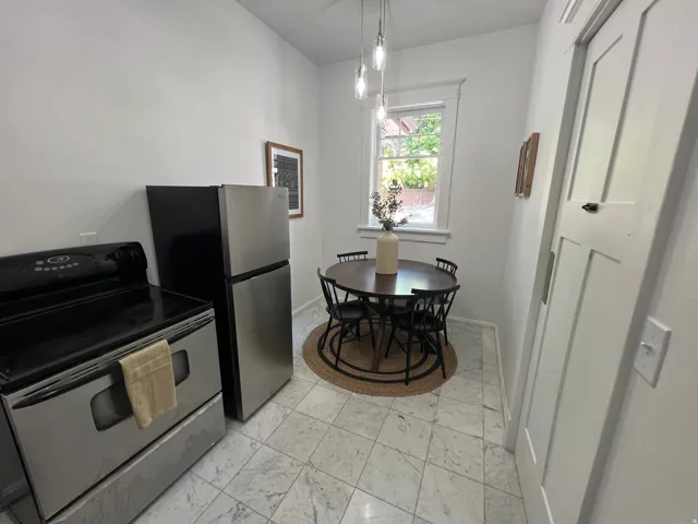 Kitchen featuring stainless steel electric range oven and pendant lighting
