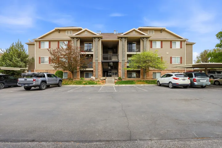 View of property with uncovered parking