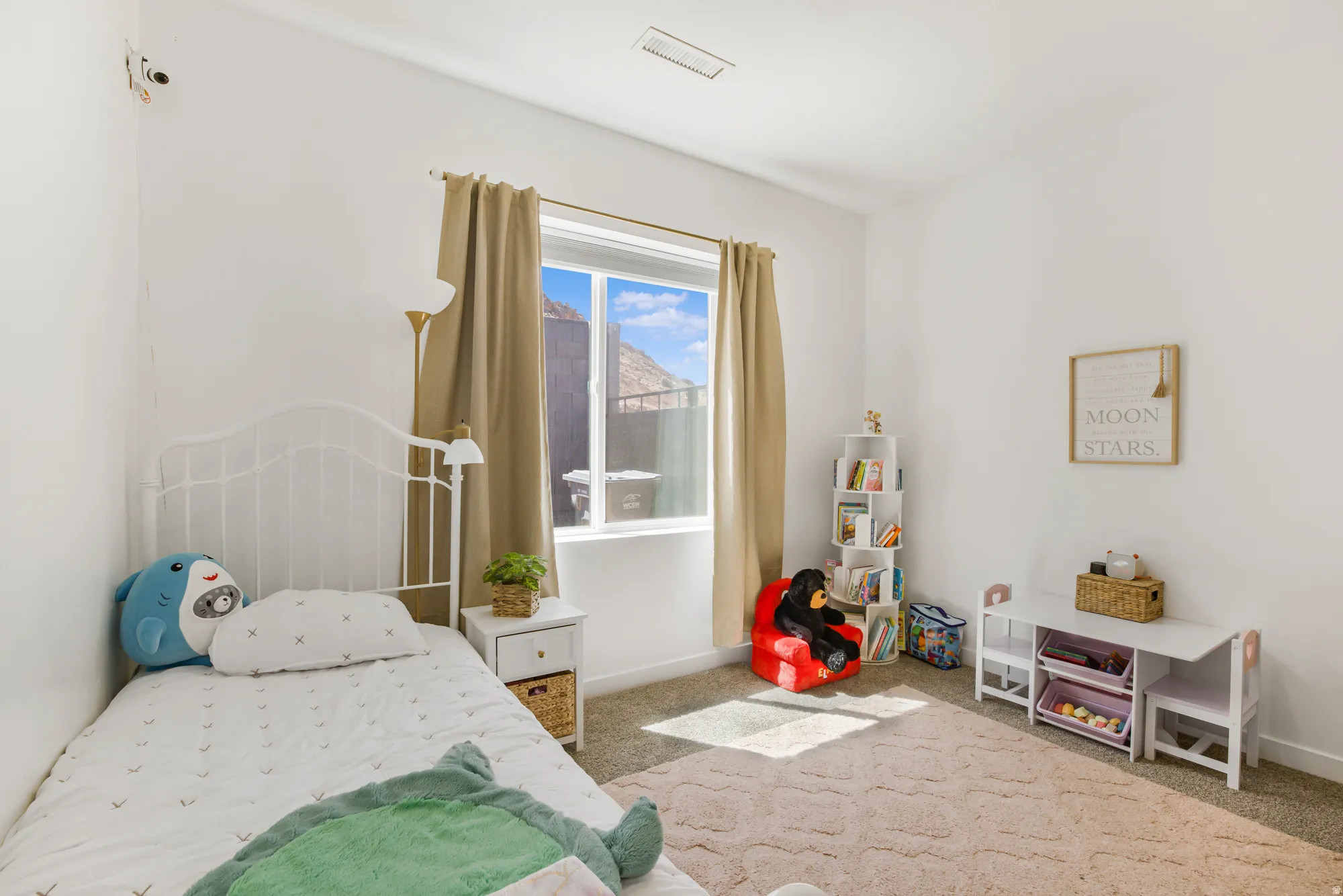 Bedroom featuring light carpet and baseboards
