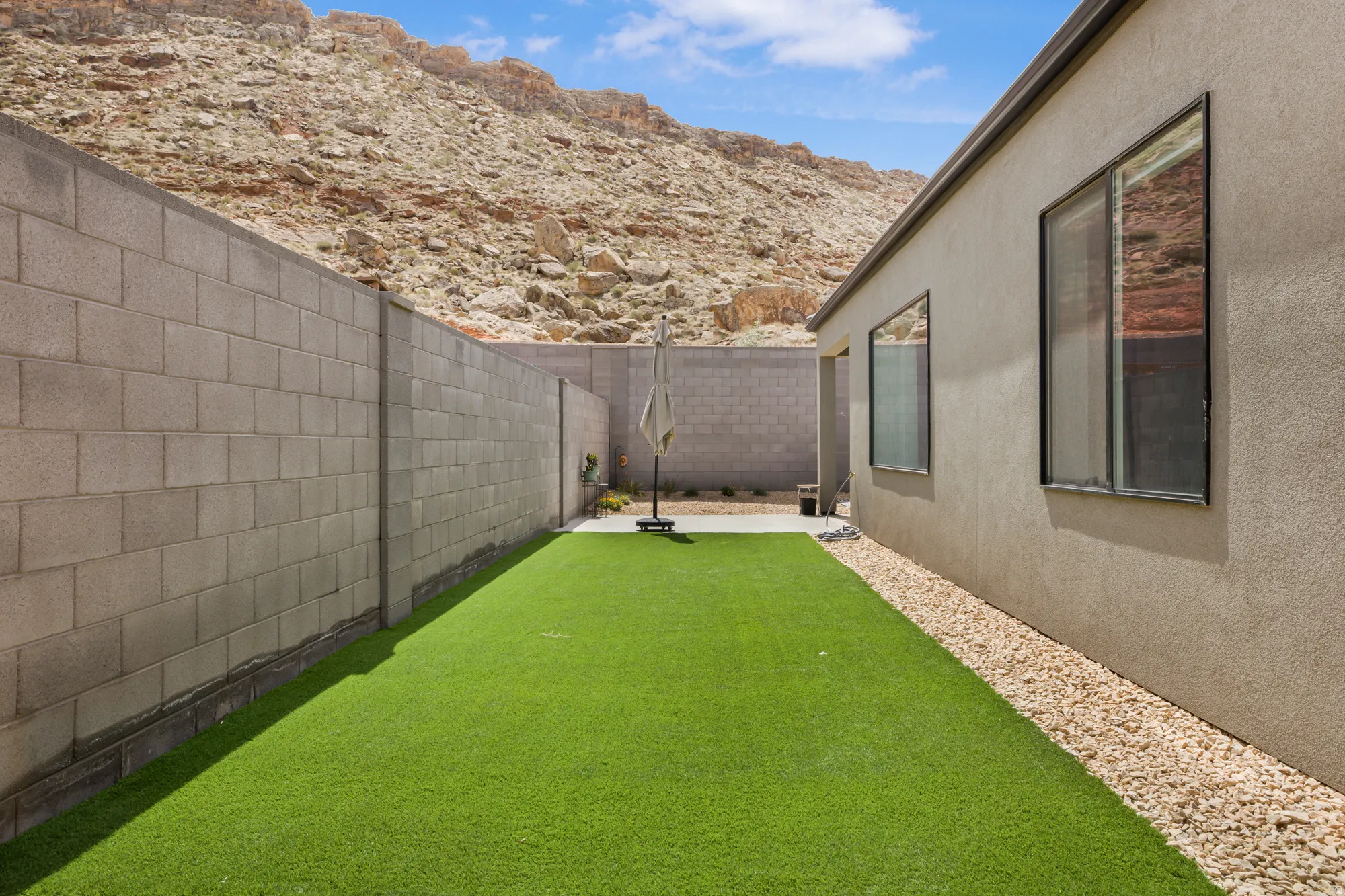 Fenced backyard featuring a patio area and a mountain view