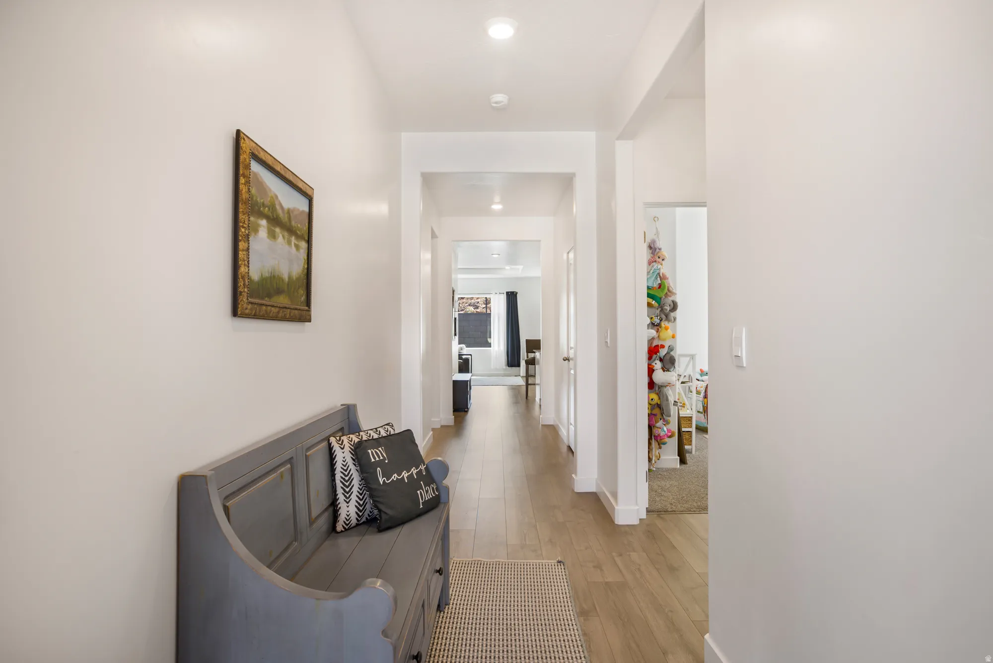 Hall featuring light wood-type flooring and recessed lighting