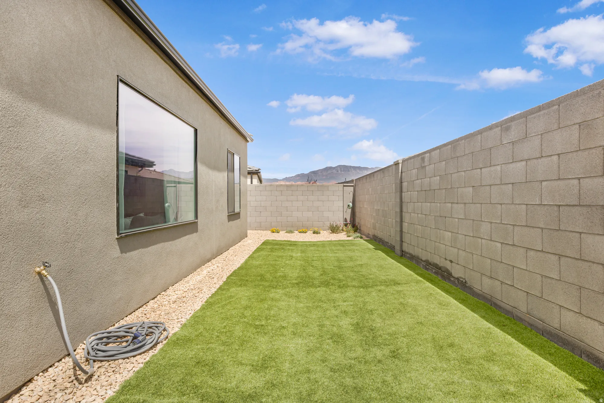 Fenced backyard featuring a mountain view