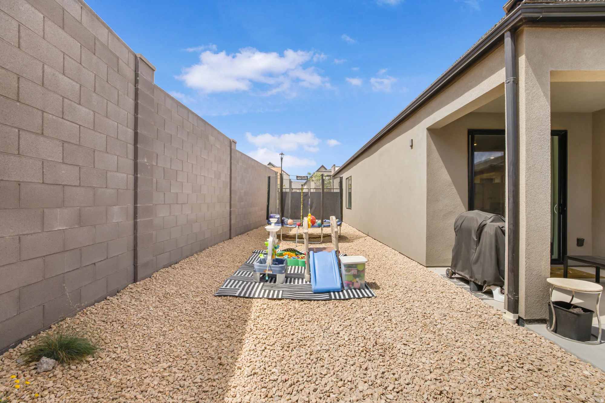 Fenced backyard with a patio