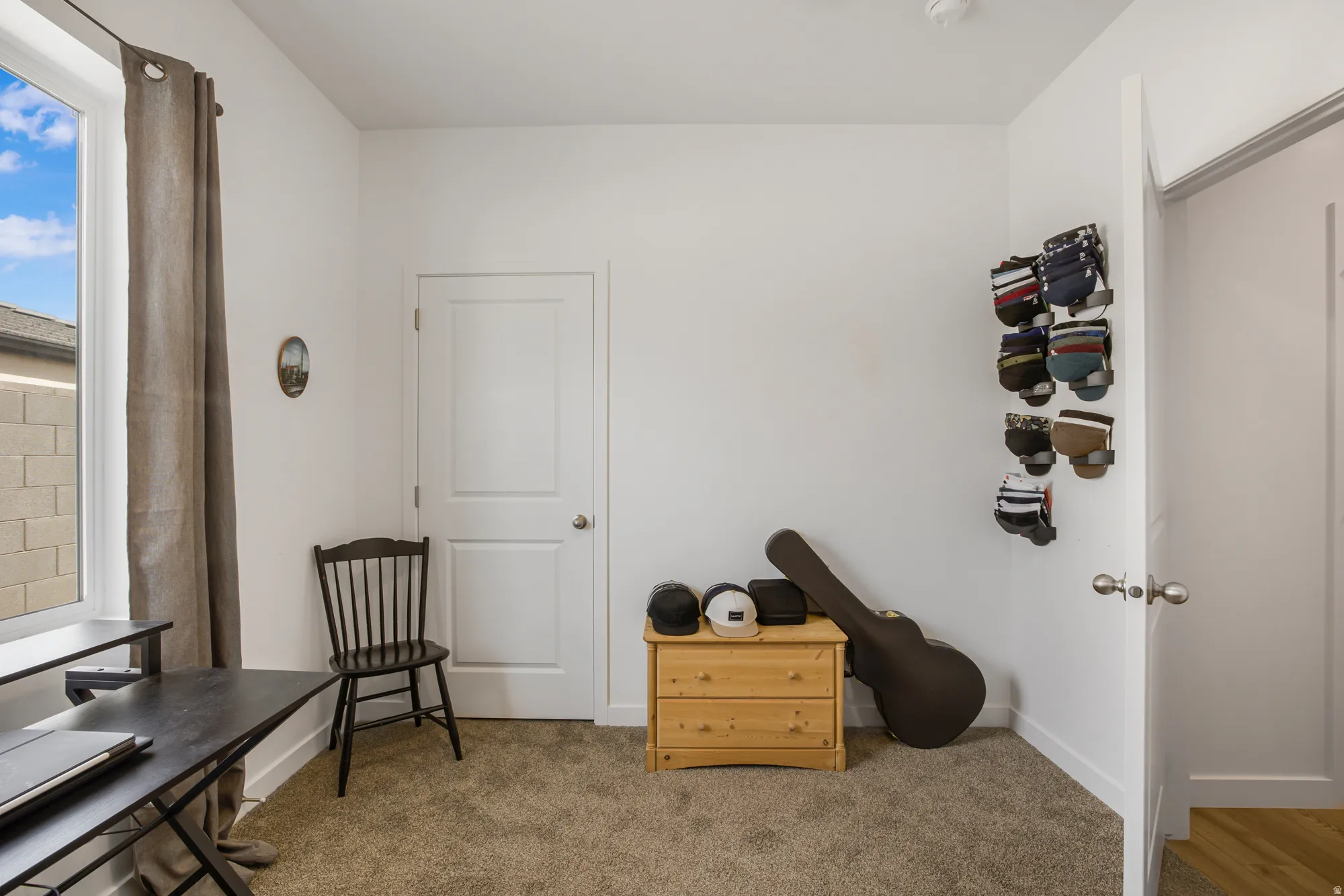 Carpeted office space with baseboards