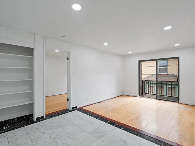 Empty room with inlaid floor details, recessed lighting, and light wood finished floors