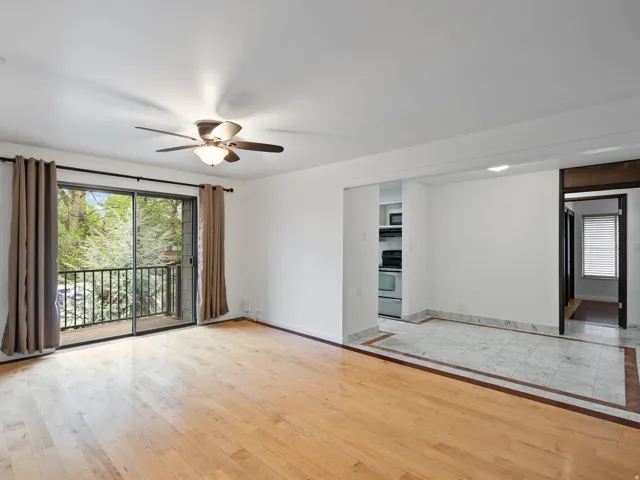 Empty room featuring light wood-style flooring and ceiling fan