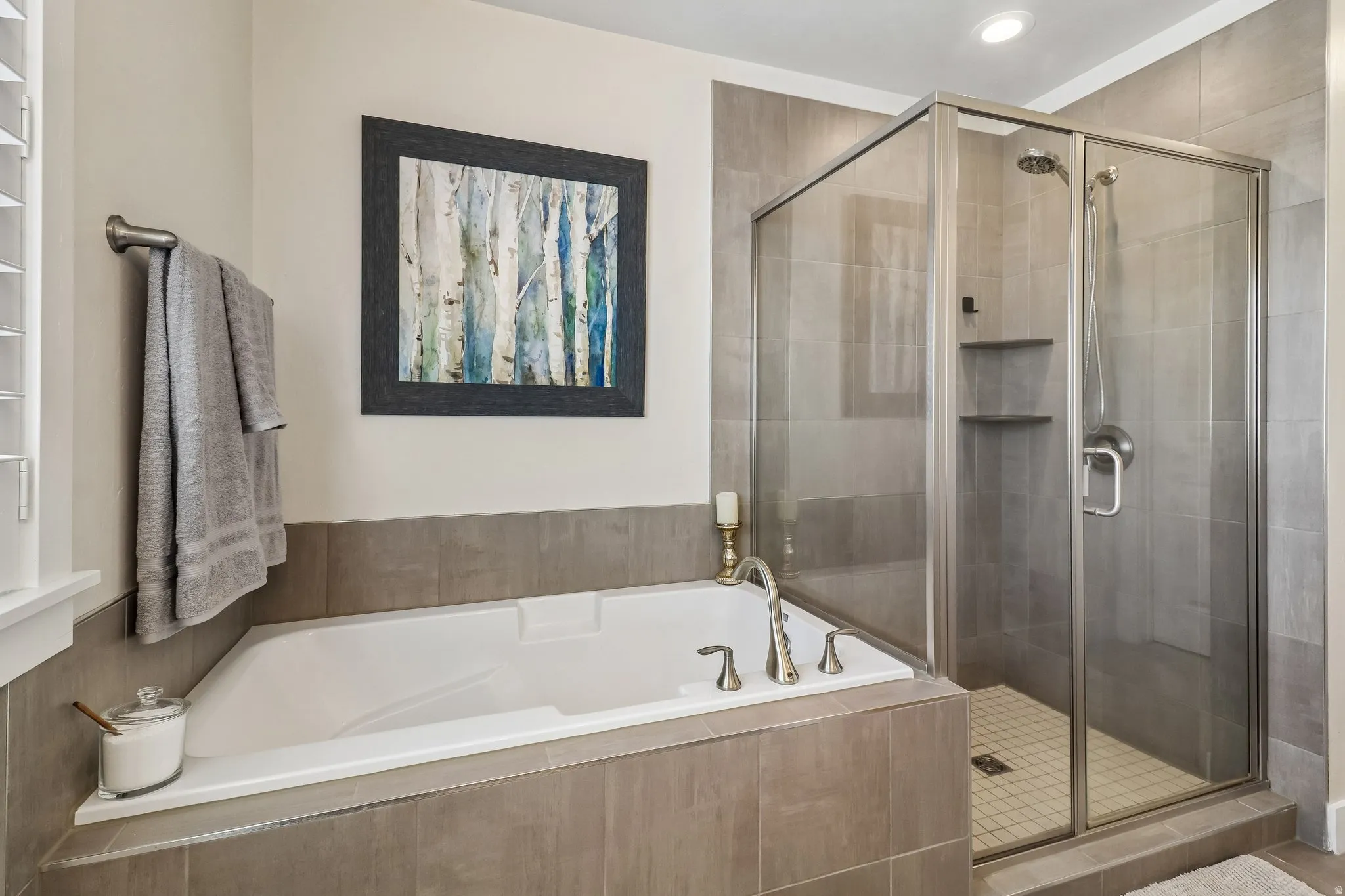 Bathroom with a stall shower and a bath