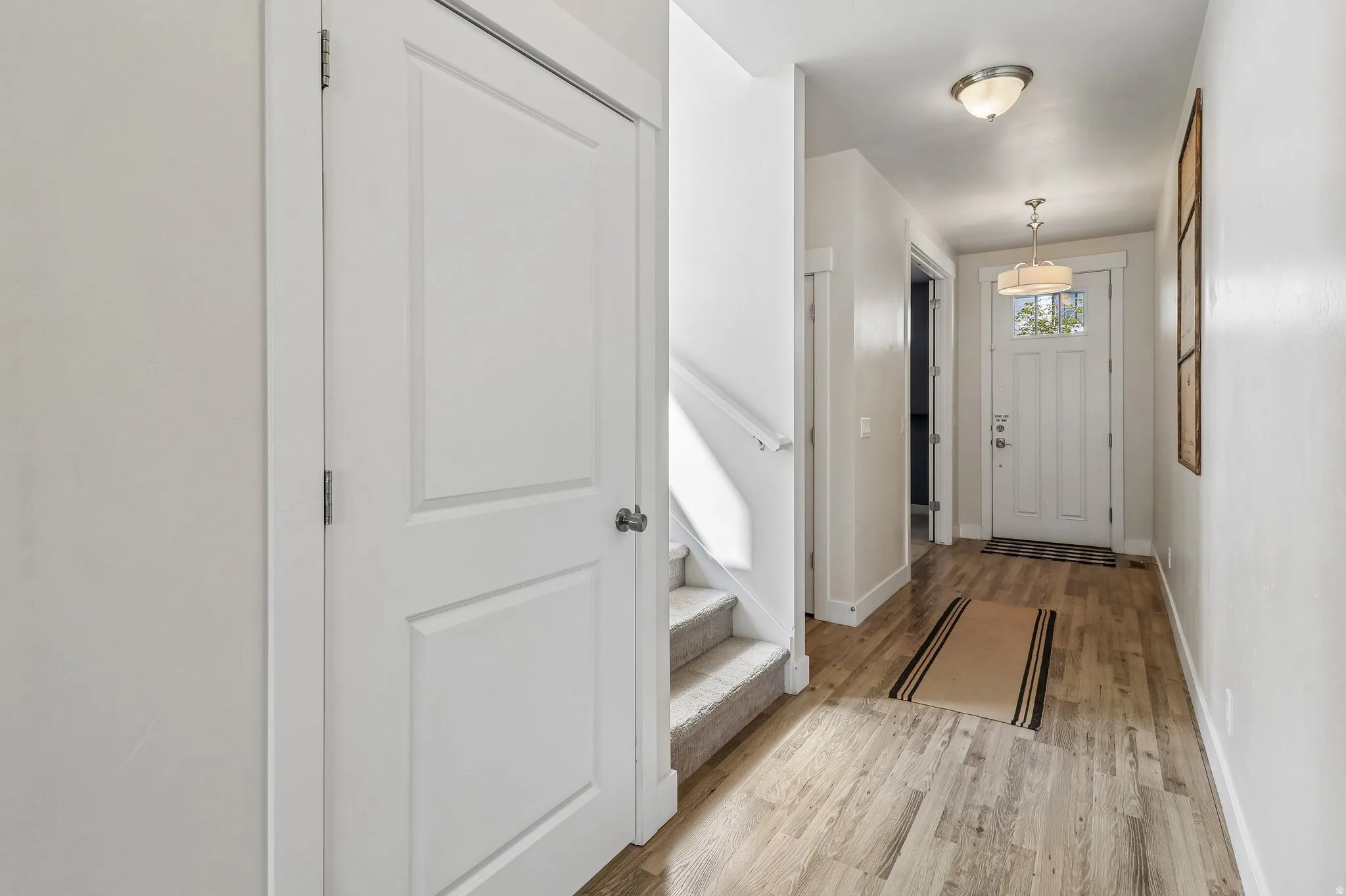 Entrance foyer featuring light wood-style floors and baseboards