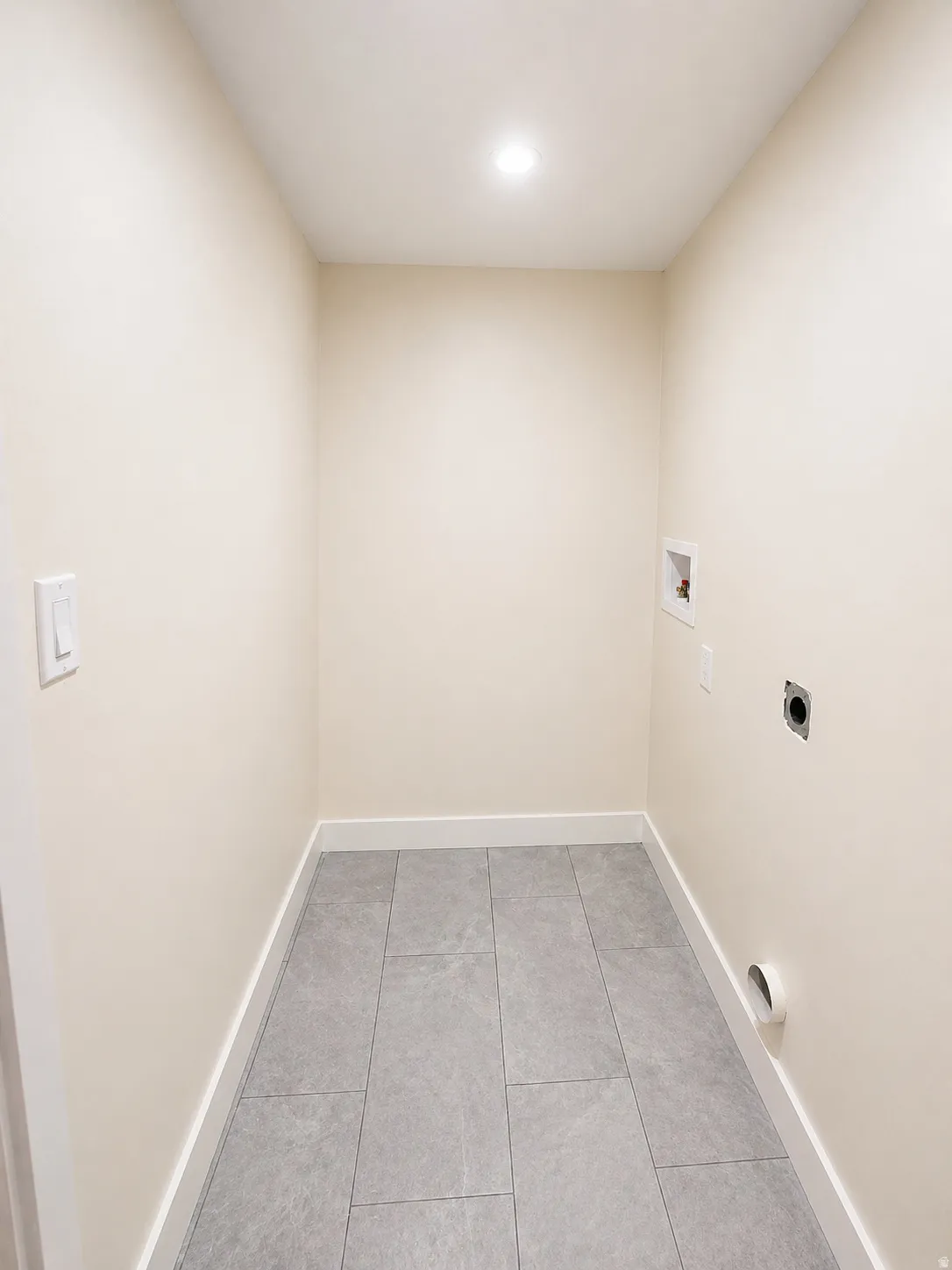 Laundry room with light tile patterned flooring, washer hookup, hookup for an electric dryer, and recessed lighting