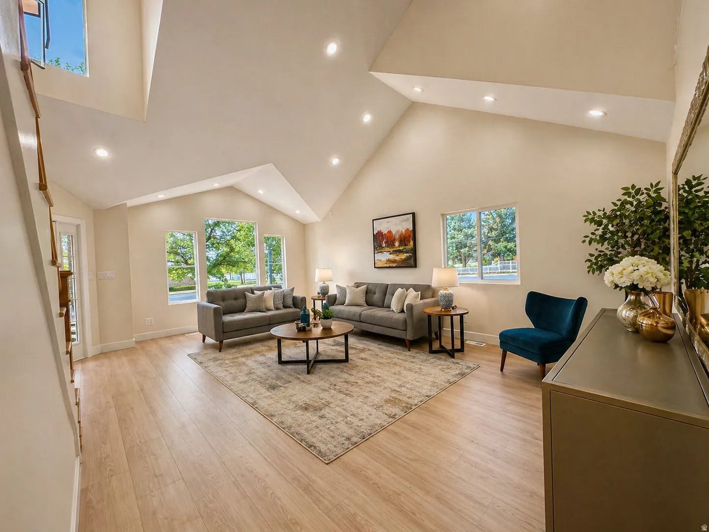 Living area featuring light wood-style flooring, recessed lighting, and vaulted ceiling
