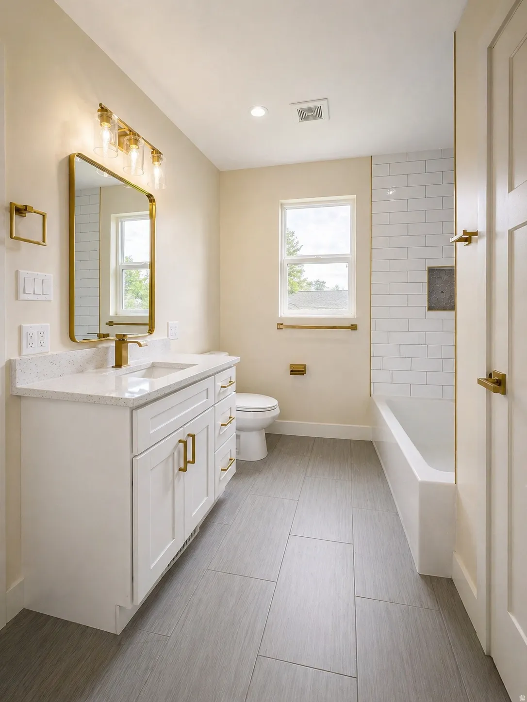 Bathroom featuring vanity, plenty of natural light, washtub / shower combination, and recessed lighting