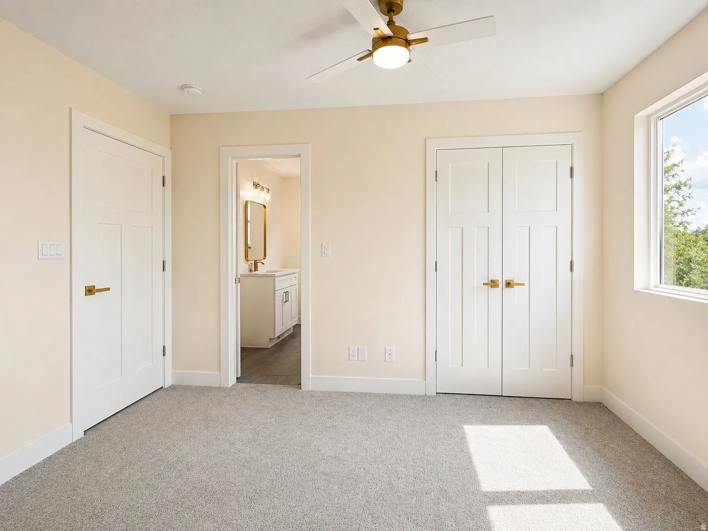 Bedroom featuring light colored carpet, connected bathroom, and ceiling fan