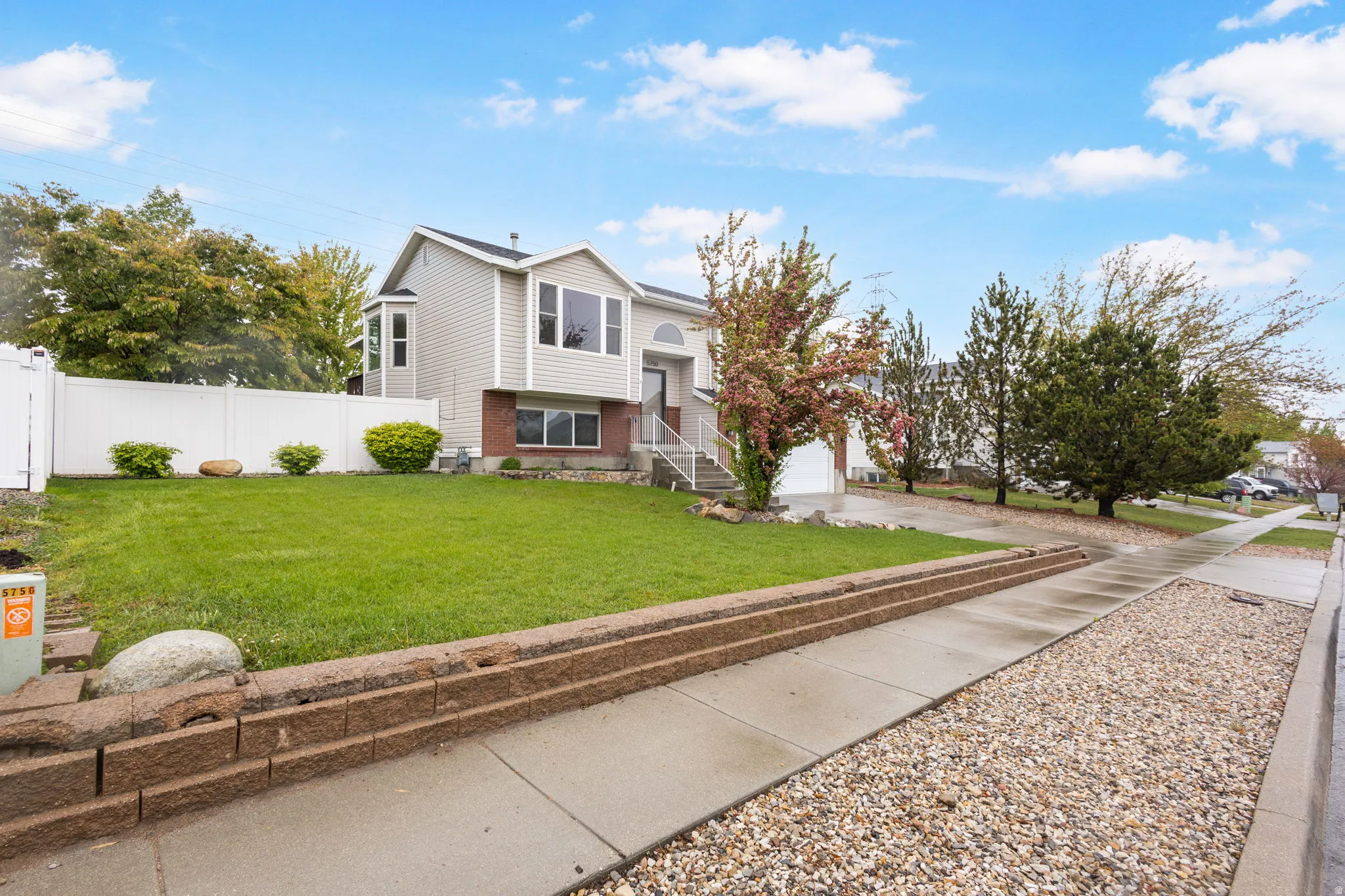 Raised ranch with a garage and concrete driveway