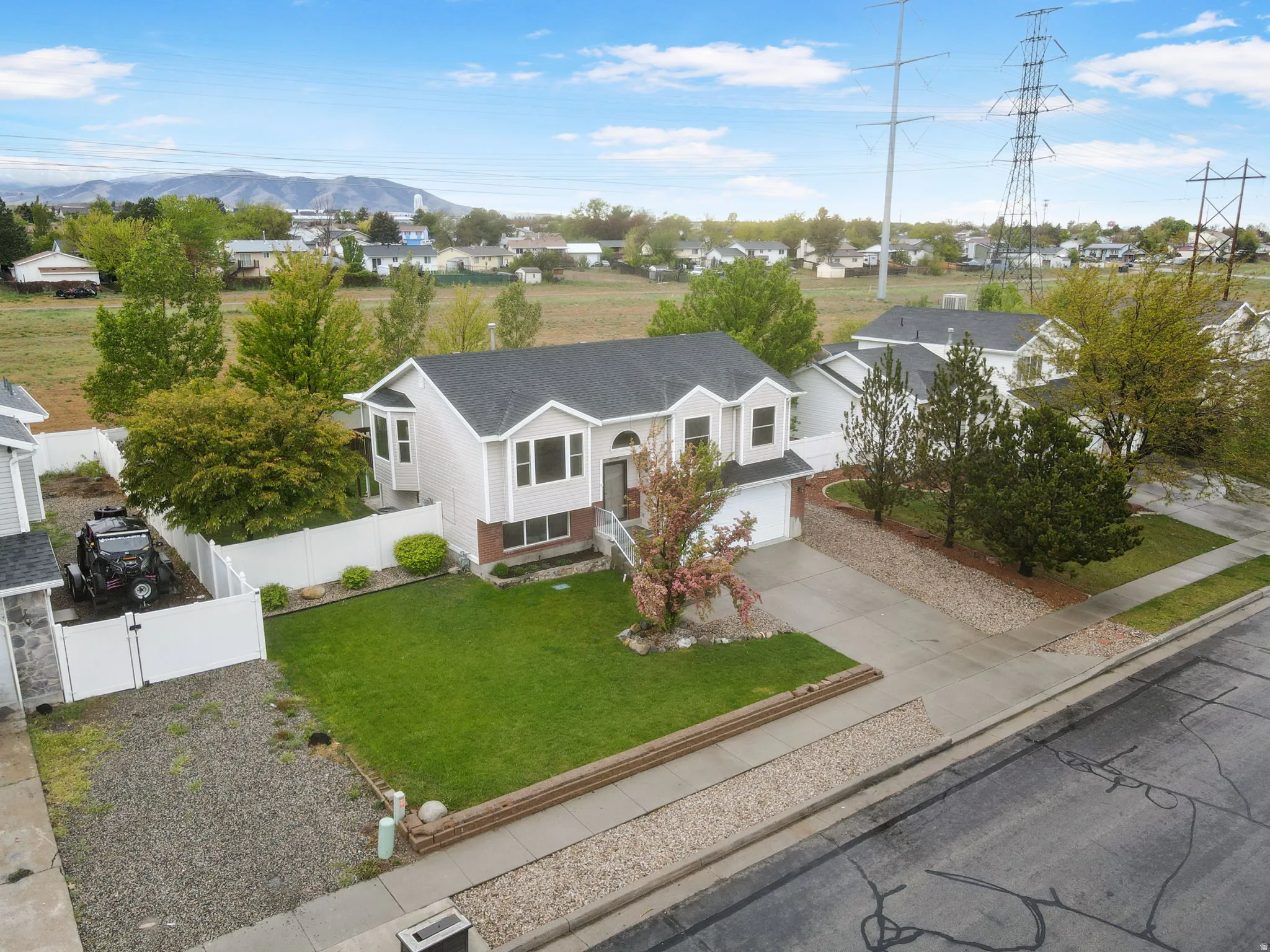View of front facade with concrete driveway, a garage, and a residential view