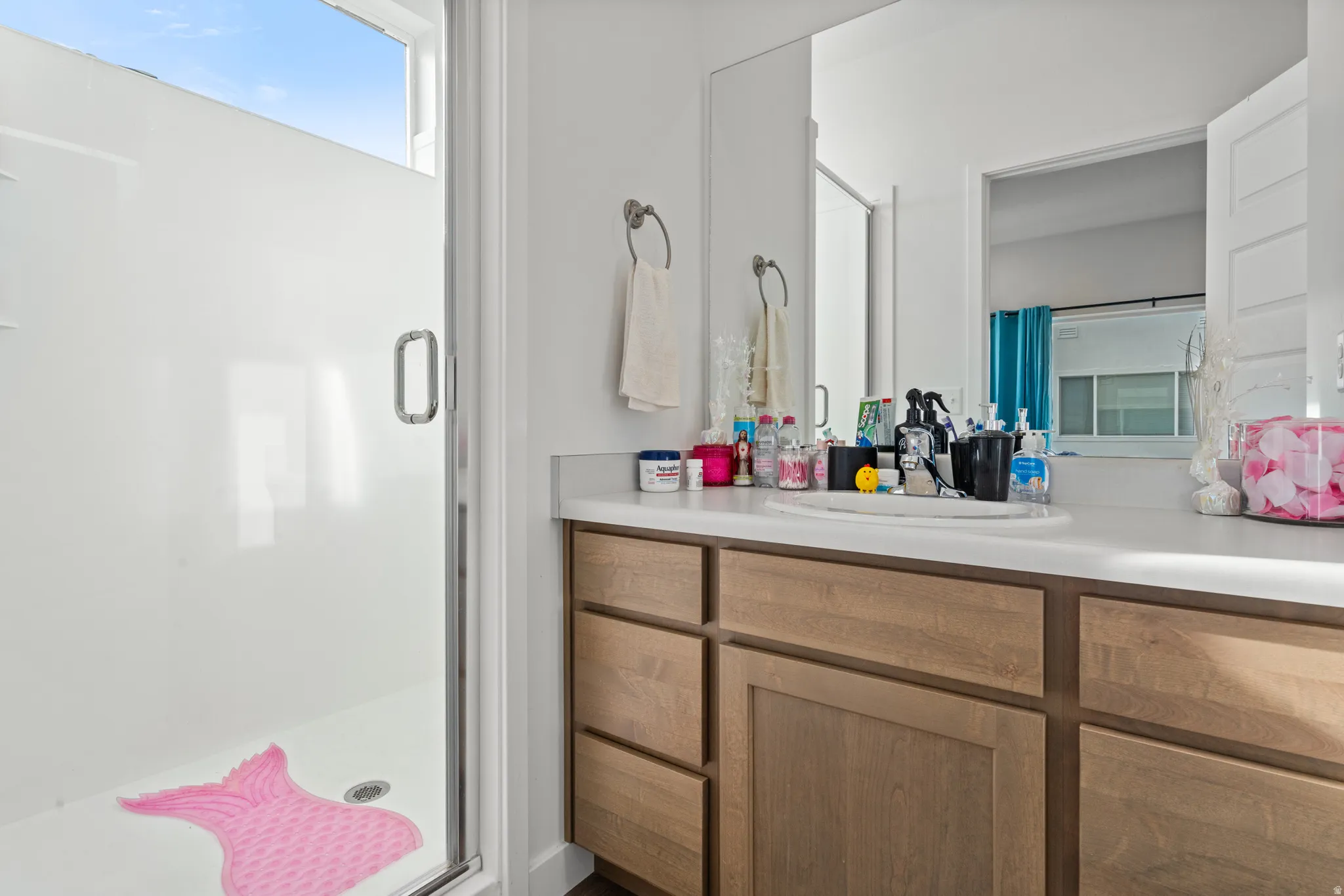 Full bath featuring a stall shower and vanity