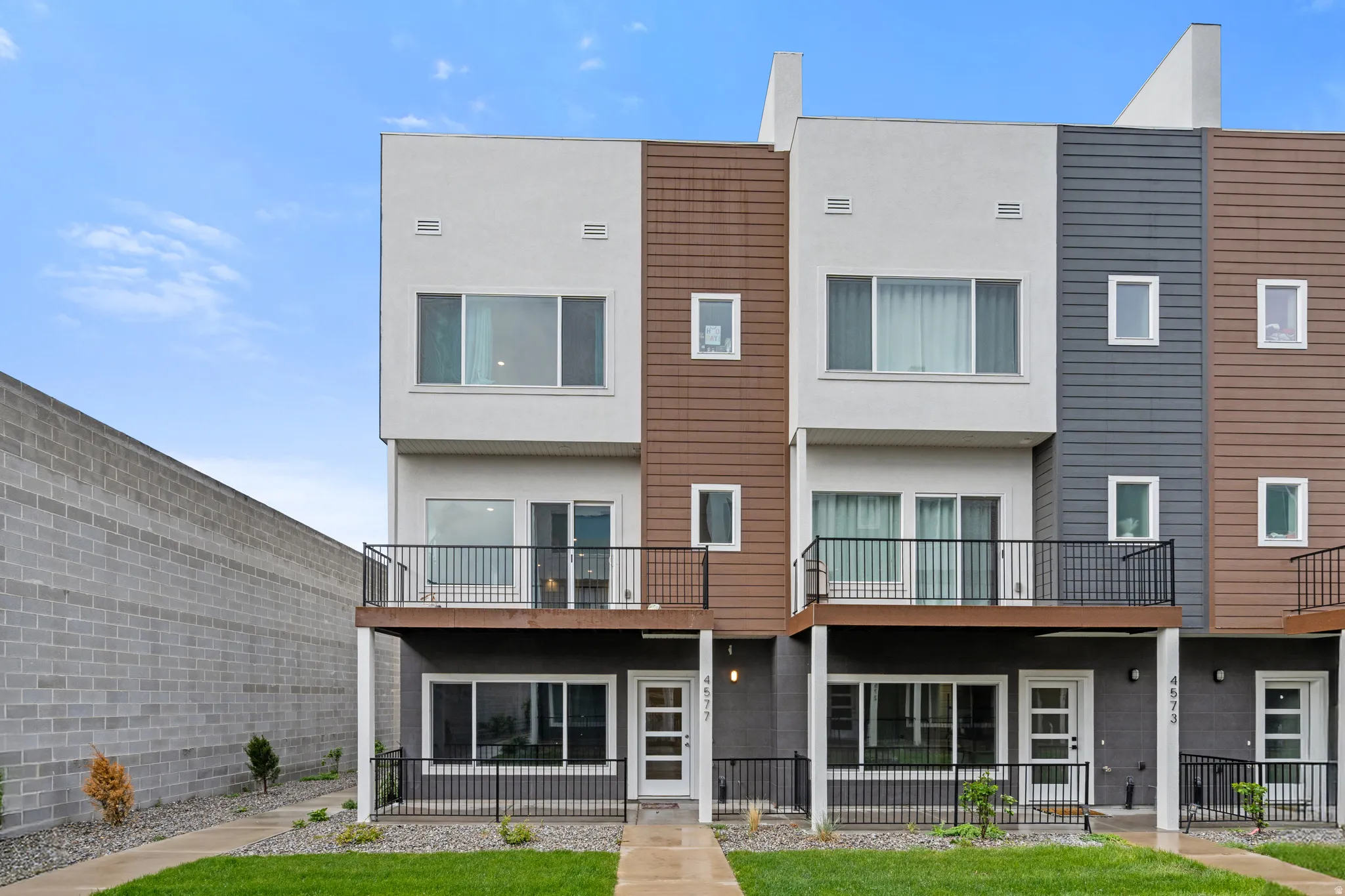 Rear view of property featuring stucco siding and a balcony