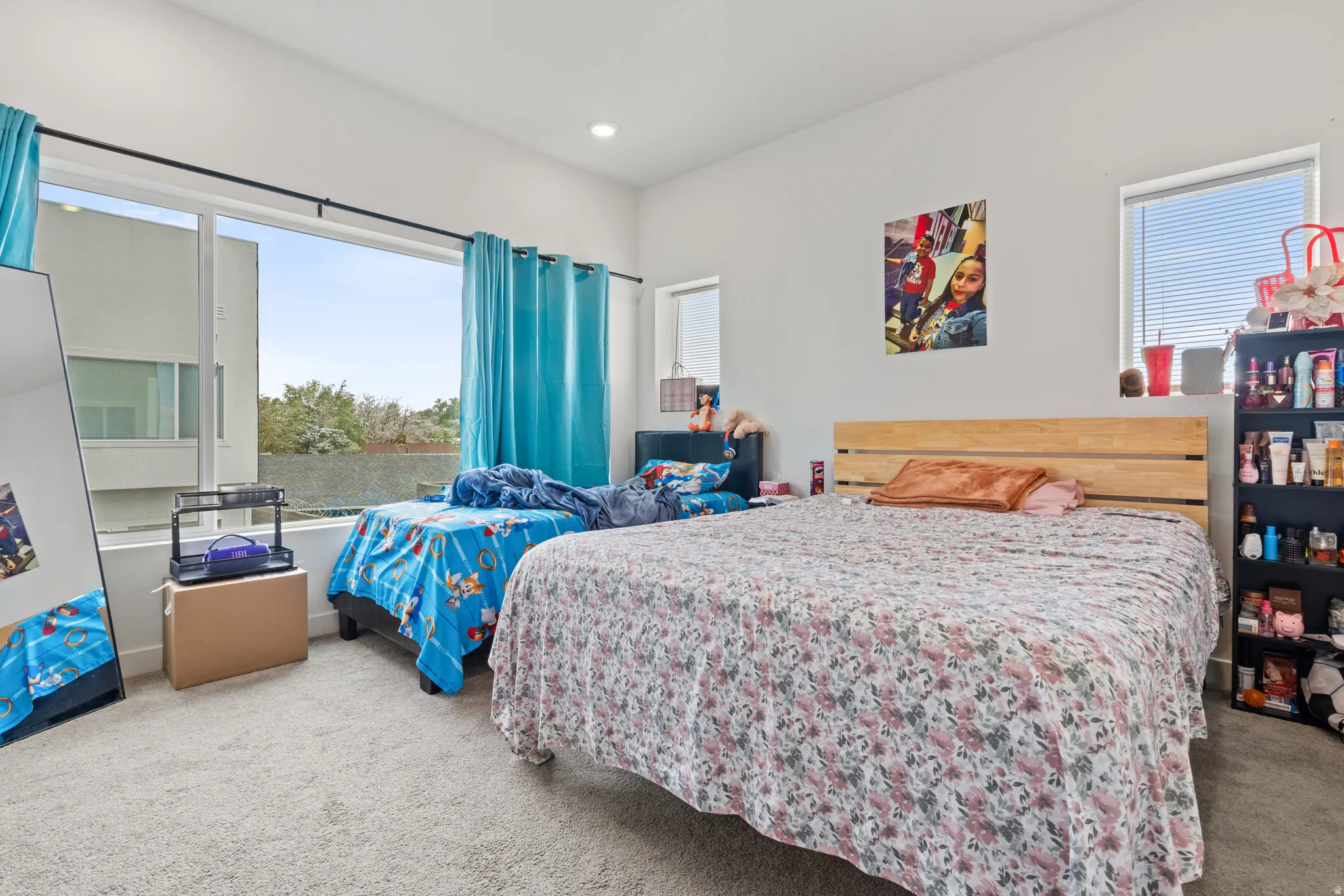 Bedroom featuring multiple windows, light colored carpet, and recessed lighting