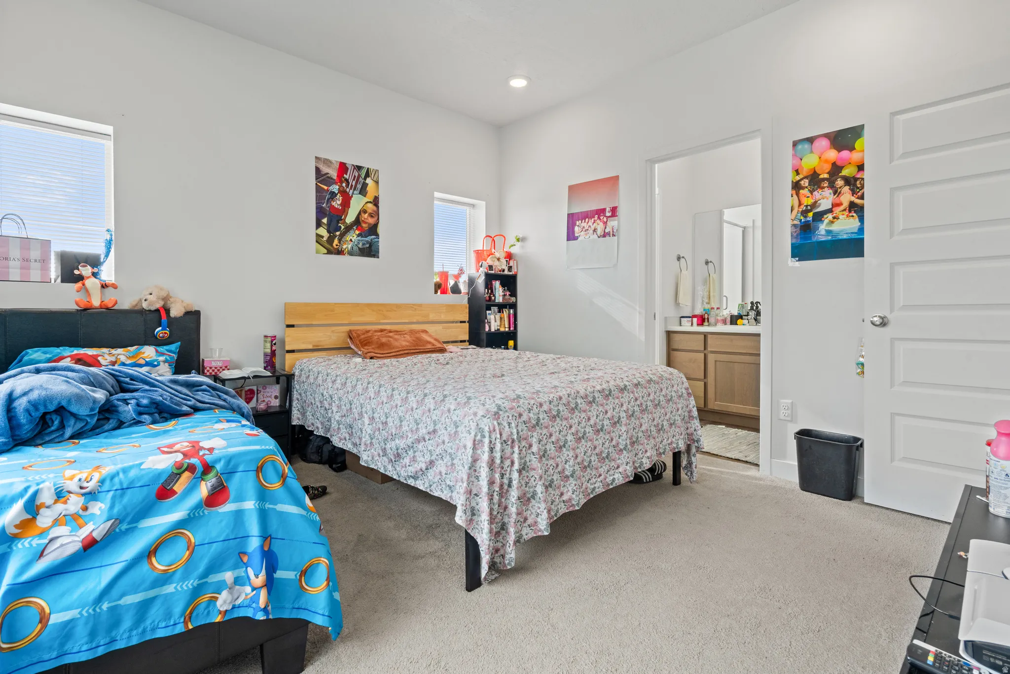 Bedroom featuring light carpet, connected bathroom, and recessed lighting
