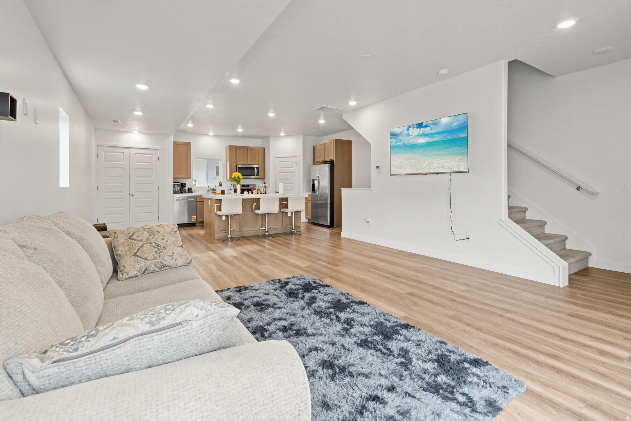 Living room featuring light wood-style floors and recessed lighting