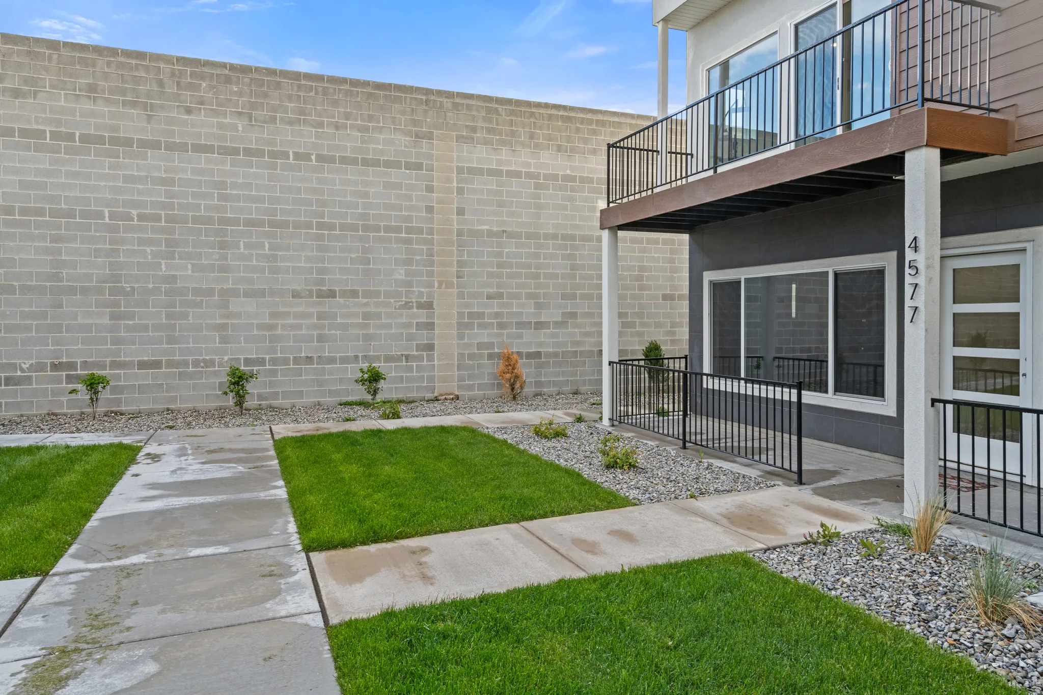 View of green lawn featuring a balcony