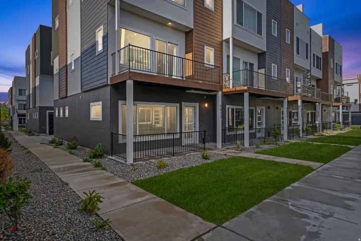 Property at dusk with a view of apartment building / complex