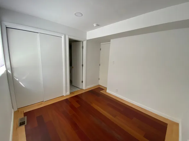 Unfurnished bedroom featuring a closet and wood finished floors