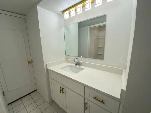 Bathroom with vanity and light tile patterned floors