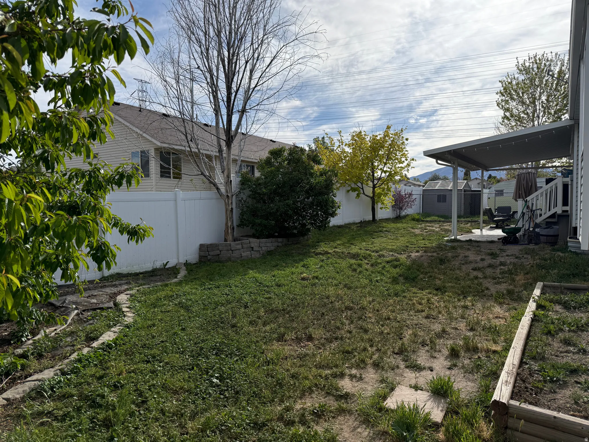 Fenced backyard with a storage unit