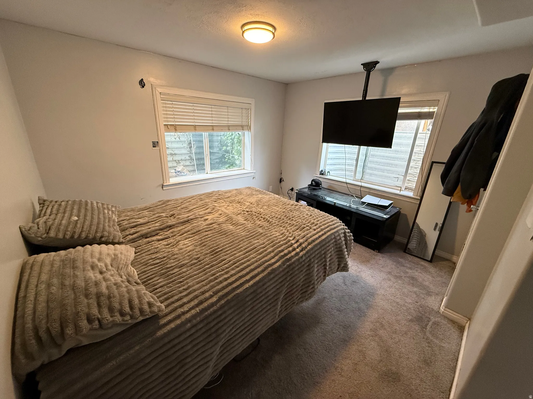 Bedroom featuring carpet floors and baseboards